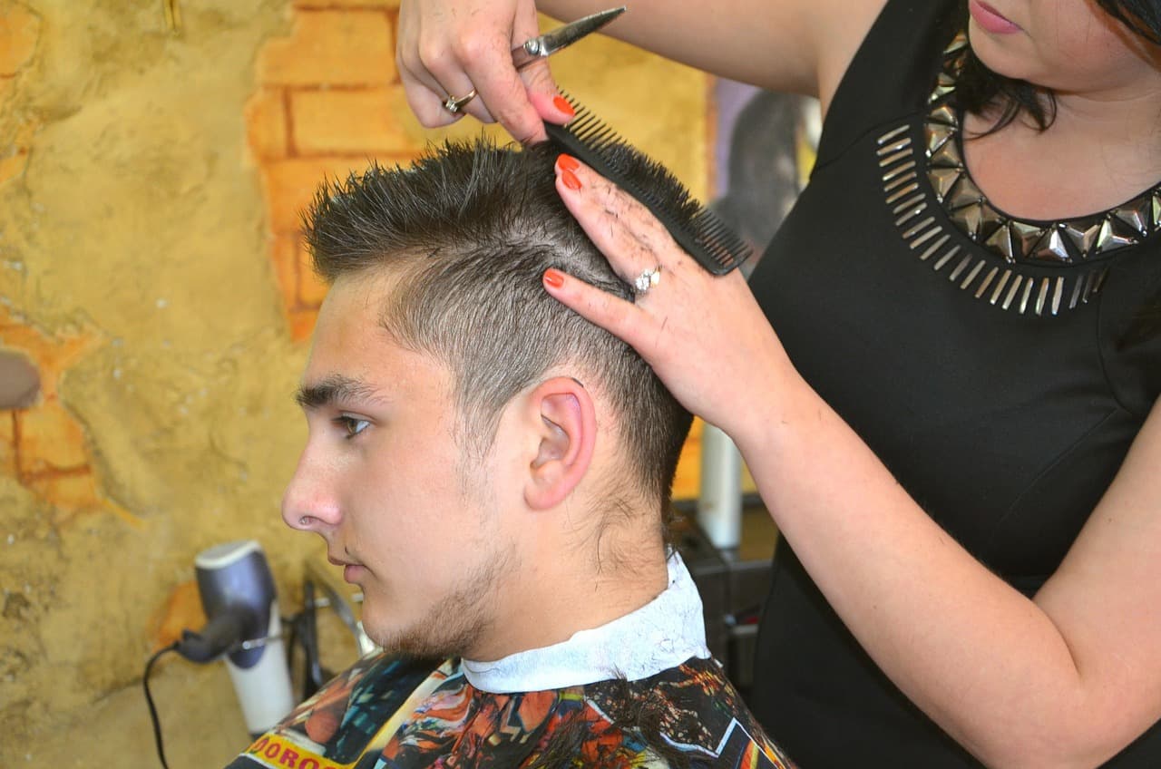 Customer's hair being shaped and styled after a cut