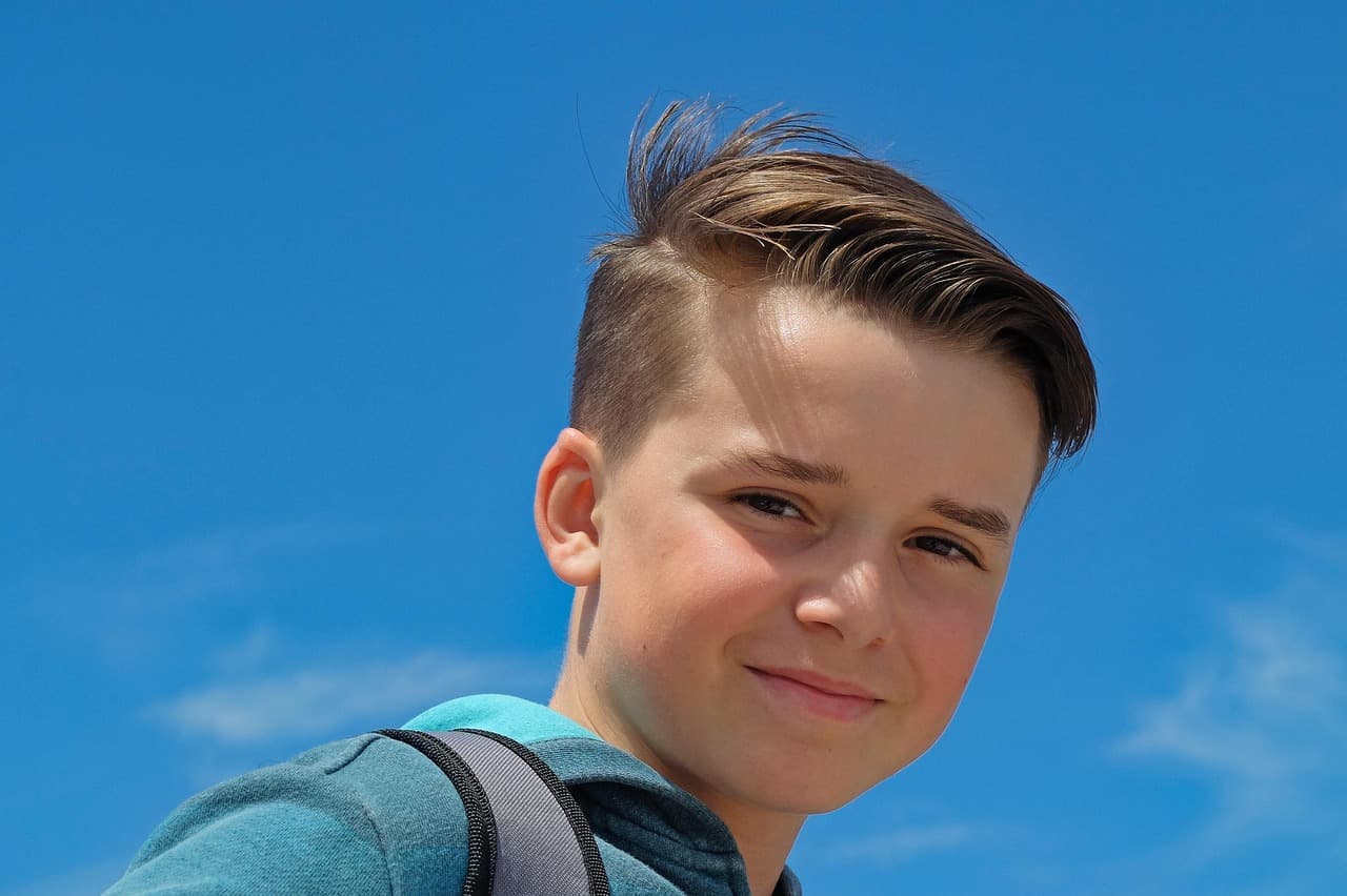 Smiling boy with a fresh short haircut
