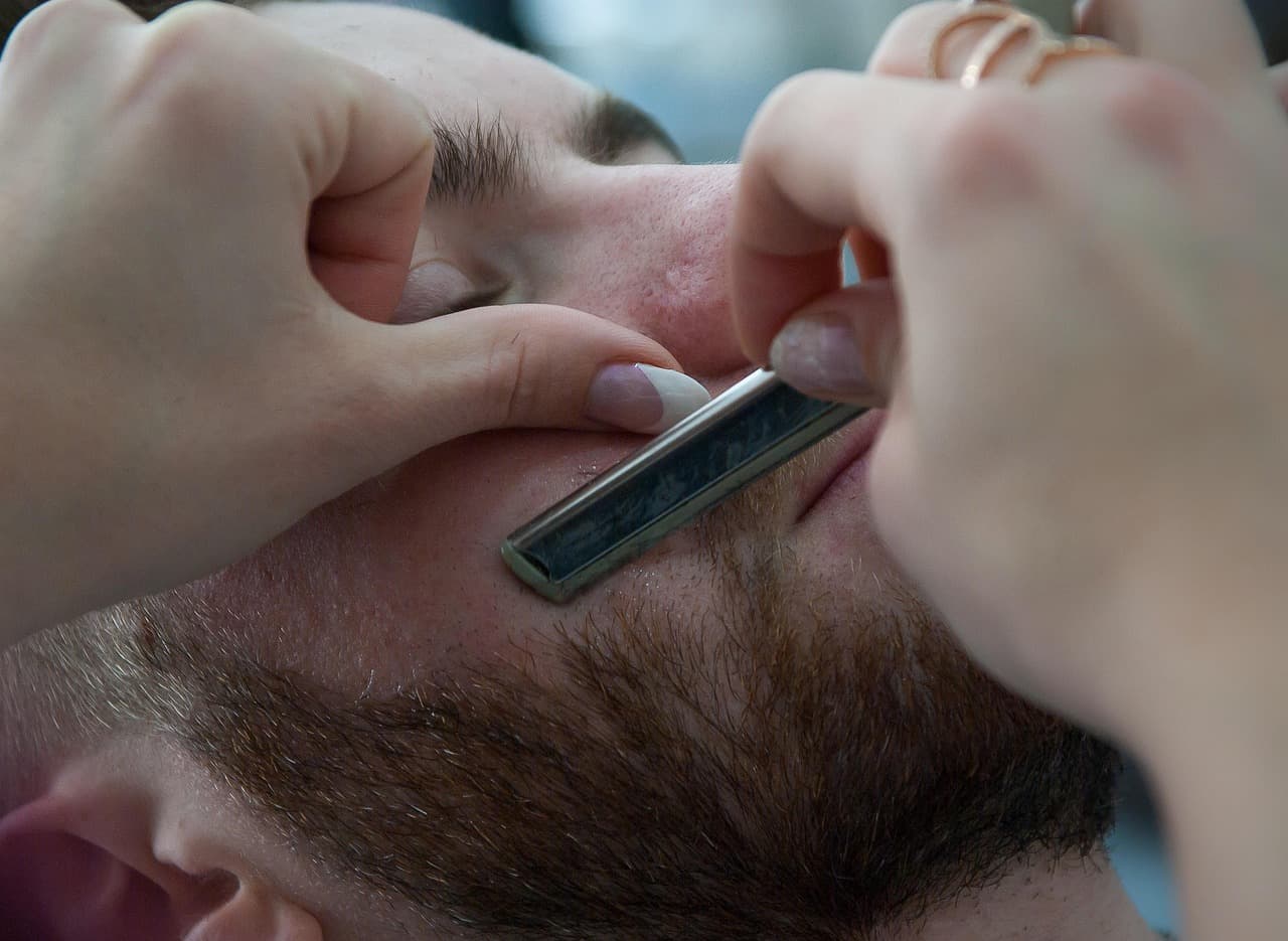 Straight razor shave along the cheek and beard line